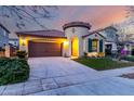 Charming home featuring a two-car garage, well-manicured lawn, and unique architectural details like a turret entrance at 15432 W Corrine Dr, Surprise, AZ 85379