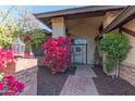 Welcoming entryway with brick pillars and vibrant flowers at 17045 N 58Th Way, Scottsdale, AZ 85254