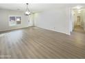 Spacious living area featuring hardwood floors and ample natural light at 2014 N 94Th Gln, Phoenix, AZ 85037