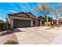 Inviting single-story home with a desert landscaped front yard, and a two-car garage on a sunny day at 21804 N 38Th Pl, Phoenix, AZ 85050