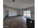 Bright living room with hardwood floors and access to the kitchen at 22216 W Skinner Rd, Wittmann, AZ 85361