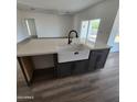 Kitchen island with farmhouse sink and quartz countertop at 22232 W Skinner Rd, Wittmann, AZ 85361