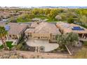 Aerial view showing the house's backyard, a patio, and surrounding landscape at 27831 N Makena Pl, Peoria, AZ 85383