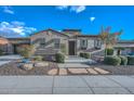 House exterior showcasing stone accents, landscaping, and a welcoming entrance at 27831 N Makena Pl, Peoria, AZ 85383