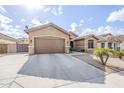 Tan house with brown garage door and a long driveway at 2803 E Cobalt St, Chandler, AZ 85225