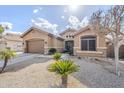 Tan house with brown garage door, landscaping, and a walkway at 2803 E Cobalt St, Chandler, AZ 85225