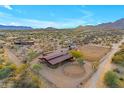 Aerial view of a ranch with barn, riding arena, and large desert lot at 32905 N 140Th St, Scottsdale, AZ 85262