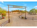 Ranch entrance with custom arch and long driveway leading to the main house at 32905 N 140Th St, Scottsdale, AZ 85262