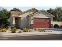 One-story home with brown garage door and desert landscaping at 330 S San Fernando Ln, Casa Grande, AZ 85194