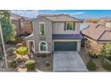 Two-story house with a green garage door and solar panels at 3617 E Half Hitch Pl, Phoenix, AZ 85050