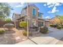 Two-story house with a green garage door and desert landscaping at 3617 E Half Hitch Pl, Phoenix, AZ 85050