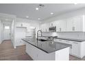 Bright kitchen featuring an island, white cabinets, and stainless steel appliances at 4120 E Ghost Flower Ln, San Tan Valley, AZ 85140