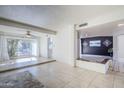 Sunlit living area featuring tile floors and a view to the backyard at 4701 E Ardmore Rd, Phoenix, AZ 85044