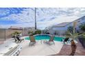 Relaxing backyard oasis with a sparkling pool, lounge chairs, and a built-in grill at 647 S Cholla St, Gilbert, AZ 85233