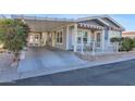 Front view of manufactured home with covered porch and landscaping at 650 N Hawes Rd # 3811, Mesa, AZ 85207