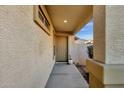 Covered entrance featuring a charming front door, stucco walls and a modern recessed light fixture at 8219 W Globe Ave, Phoenix, AZ 85043