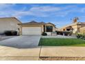 Inviting one-story home with manicured landscaping, artificial turf and a well-maintained exterior at 8219 W Globe Ave, Phoenix, AZ 85043