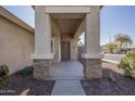 Front entrance with covered porch and stone accents at 11029 W Mountain View Dr, Avondale, AZ 85323