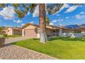 House exterior showcasing a garage and well-maintained lawn at 12506 W Castle Rock Dr, Sun City West, AZ 85375