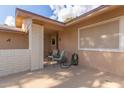 Covered patio with brick columns, seating, and a garden hose at 12506 W Castle Rock Dr, Sun City West, AZ 85375