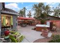 Relaxing backyard with hot tub, patio furniture, and a covered patio area at 12522 W Llano Dr, Litchfield Park, AZ 85340