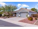 Two-story house with a three-car garage and desert landscaping at 12522 W Llano Dr, Litchfield Park, AZ 85340