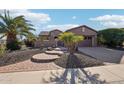 Single-story home with circular walkway and palm trees at 12911 W Eagle Ridge Ln, Peoria, AZ 85383