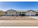 A charming single-story home features a spacious driveway and low maintenance desert landscaping at 13219 W Prospect Dr, Sun City West, AZ 85375