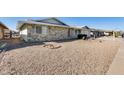 A charming single-story home features low maintenance desert landscaping at 13219 W Prospect Dr, Sun City West, AZ 85375