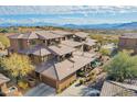 Aerial view showcasing the home's architectural style and mountain backdrop at 16333 E Lombard Pl, Fountain Hills, AZ 85268