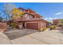 View of the home's exterior, highlighting the garage and landscaping at 16333 E Lombard Pl, Fountain Hills, AZ 85268