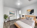 Bright bedroom with wood-look floors and stylish dresser at 2028 E Lipizzan Dr, San Tan Valley, AZ 85140