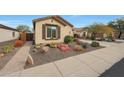 Single-story home with desert landscaping and a large driveway at 20587 N 259Th Dr, Buckeye, AZ 85396