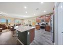 Modern kitchen with island, stainless steel appliances, and granite countertops at 20587 N 259Th Dr, Buckeye, AZ 85396