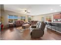 Bright living room featuring hardwood floors, leather sofas, and a view of the kitchen at 20587 N 259Th Dr, Buckeye, AZ 85396