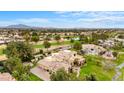 Expansive aerial view showcases an estate home with a pool and a lush green golf course at 21 E Oakwood Hills Dr, Chandler, AZ 85248