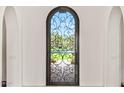 Elegant arched doorway with decorative ironwork offering picturesque views of the lush outdoor scenery at 21 E Oakwood Hills Dr, Chandler, AZ 85248