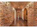 Hallway with brick accent wall and wine cellar alcove at 21 E Oakwood Hills Dr, Chandler, AZ 85248