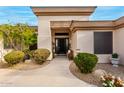 Inviting front entry with a modern door and well-maintained landscaping at 21215 N 75Th St, Scottsdale, AZ 85255