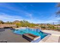 Relaxing pool area with built-in fire pit at 31689 N 128Th Dr, Peoria, AZ 85383