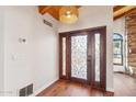 Elegant entryway featuring a wood door with ornate glass and hardwood floors at 3174 E Marlette Ave, Phoenix, AZ 85016