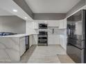 Modern kitchen with stainless steel appliances and white cabinets at 355 E Thomas Rd # B206, Phoenix, AZ 85012