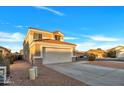 Two-story house with a two-car garage and desert landscaping at 3702 W Naomi Ln, San Tan Valley, AZ 85144