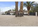 Attractive single-story home with desert landscaping, modern garage door, and dark accents at 4059 E Cholla St, Phoenix, AZ 85028