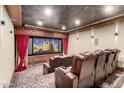 Home theater with luxurious leather seating and large projection screen at 4208 N Via Cobre Cir, Mesa, AZ 85207