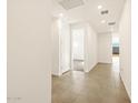 Bright hallway showcases tile flooring, recessed lighting, and leads to carpeted room at the end at 4267 W Jeanette Ln, San Tan Valley, AZ 85144