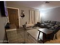 Living room with gray couch and a TV at 4417 N 70Th Ave, Phoenix, AZ 85033