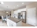 Spacious kitchen with granite countertops, stainless steel appliances, and white cabinets at 4647 E County Down Dr, Chandler, AZ 85249