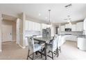 Eat-in kitchen with white cabinets, granite countertops, and a breakfast table at 4647 E County Down Dr, Chandler, AZ 85249