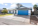 House exterior showcasing a blue garage door and front yard at 4749 E Evergreen St, Mesa, AZ 85205